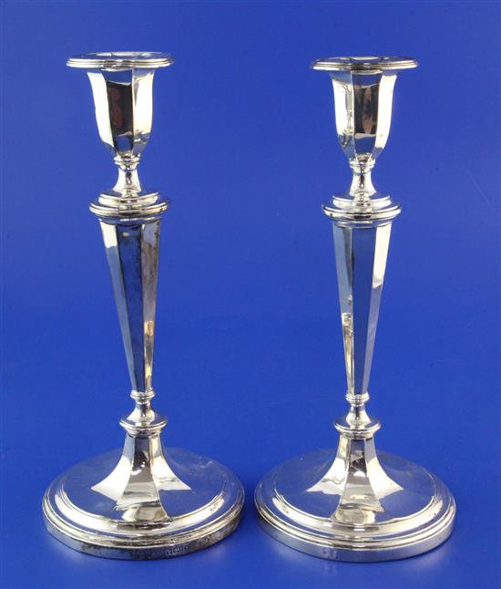 A pair of Edwardian silver candlesticks, weighted.